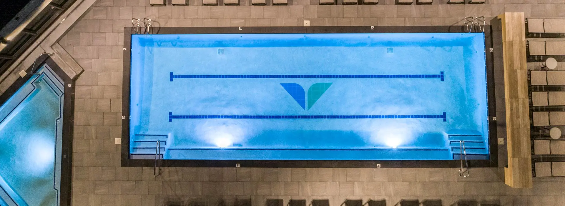 The pool at The Cliff Spa, lit up at night