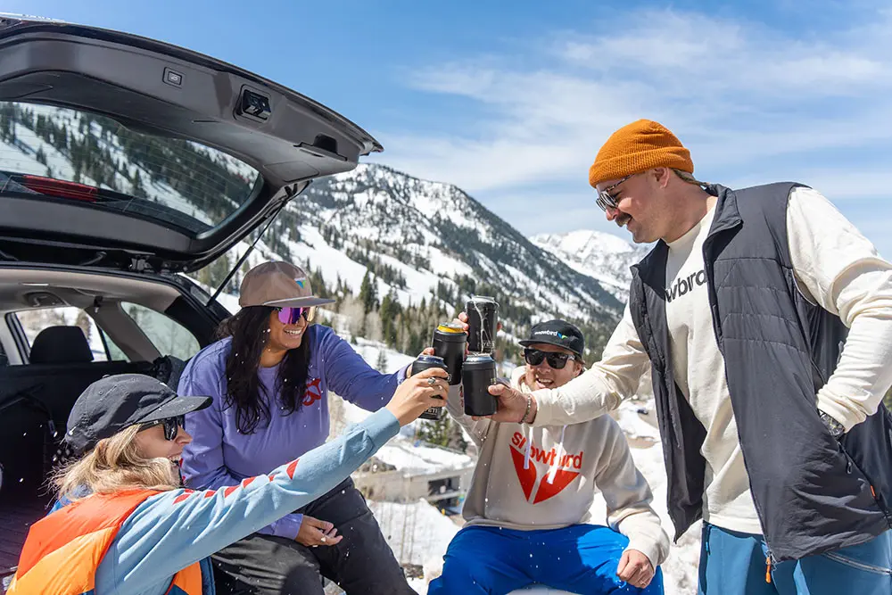 Group cheers in the back of a car parked in a carpool spot at Snowbird