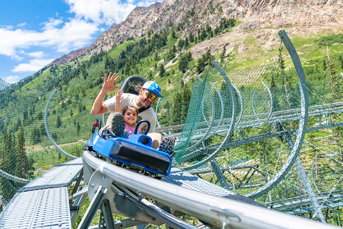 Dad and daughter on mountain coaster at Summer Activities at Snowbird