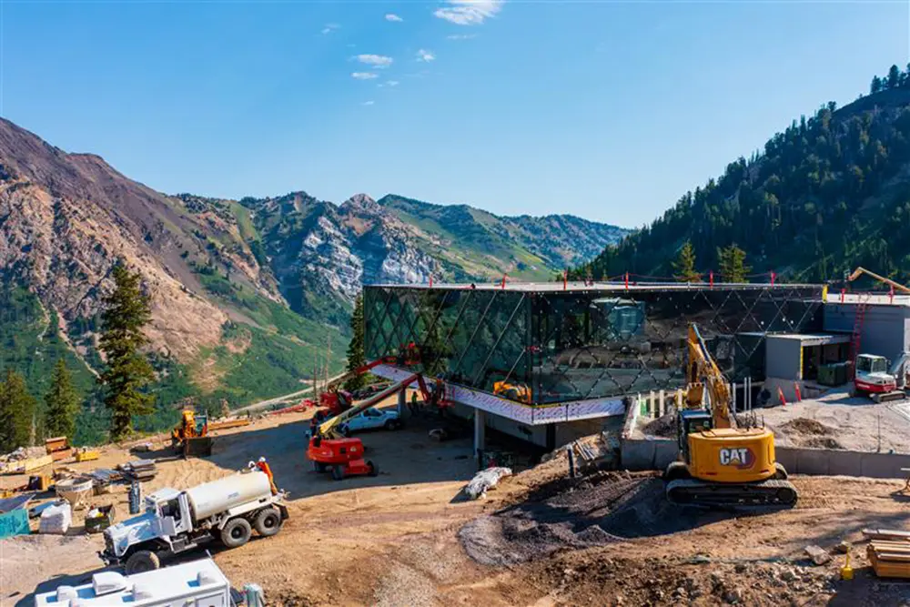 Cranes and other machinery work to install exterior windows at Snowbird's new mid-mountain restaurant