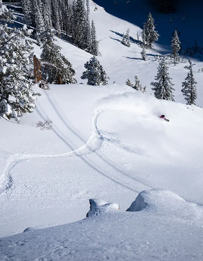 Snowboarder goes down a slope mobile hero for season pass sales