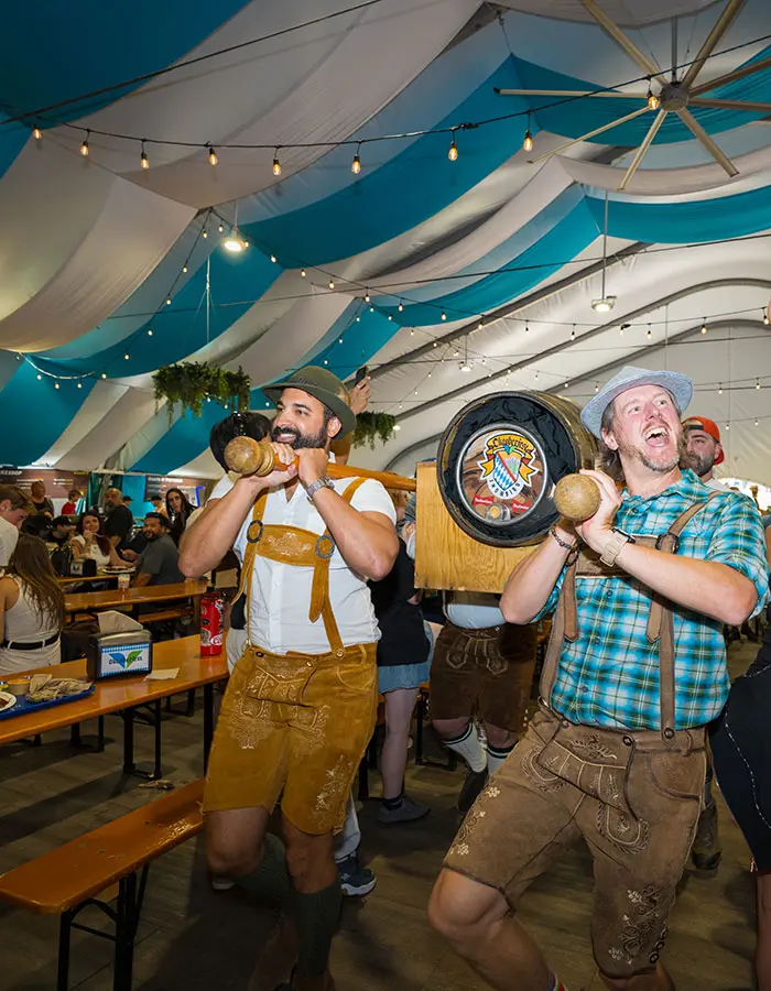 Mobile hero of folks carrying in a keg to the grand halle at oktoberfest