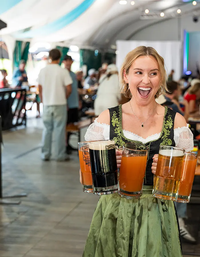 Mobile hero of girl carrying 4 beers at Snowbird's Oktoberfest