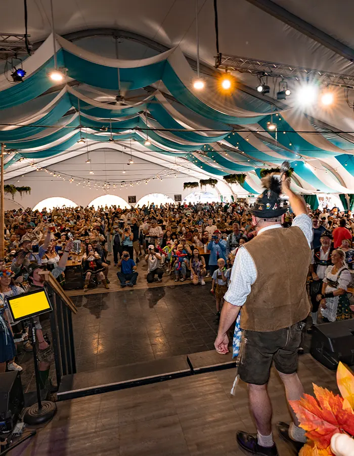 Bürgermeister leads a cheers in the Halle Tent at Snowbird Oktoberfest - mobile hero