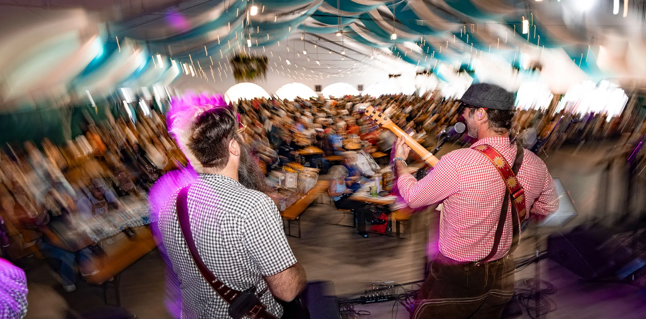 Oktoberfest halle tent, 2 guitarists on stage playing to the crowd
